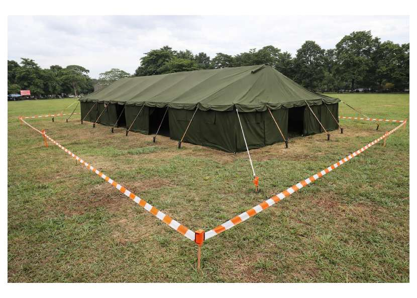 Foto setup tenda pleton 6x12 meter di lapangan terbuka dengan clearance area dan tali pasak terlihat jelas